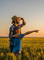 Bundaberg farmer & son look off into the sunset standing amongst crops